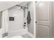 Clean bathroom features a shower with white subway tile, black hardware, and a decorative accent tile at 341 Sanders St, Indianapolis, IN 46225
