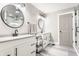 Luxurious bathroom with double sinks, black hardware, modern lighting, and marble-look tile at 341 Sanders St, Indianapolis, IN 46225
