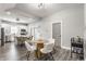 Dining area with wood table and open layout, flowing to the kitchen with white cabinets and island at 341 Sanders St, Indianapolis, IN 46225