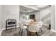 Dining area with a wood table, modern white chairs, and an open view to the living room and kitchen at 341 Sanders St, Indianapolis, IN 46225