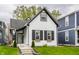 Charming renovated home with modern black and white trim, steps to the front door, and lush green lawn at 341 Sanders St, Indianapolis, IN 46225