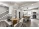 Open-concept kitchen with white cabinets, stainless steel appliances, and a dining area with chairs at 341 Sanders St, Indianapolis, IN 46225