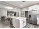 Bright kitchen with white cabinets, stainless steel refrigerator, and a center island perfect for cooking at 341 Sanders St, Indianapolis, IN 46225