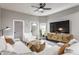 Living room featuring a gray sectional couch, geometric wood coffee table, and a cabinet-mounted television at 341 Sanders St, Indianapolis, IN 46225