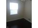 Bedroom with hardwood floors and natural light from the window at 3505 N Layman Ave, Indianapolis, IN 46218