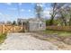 Charming home with a gravel driveway and wooden gate leading to a fenced backyard at 3624 Wallace Ave, Indianapolis, IN 46218