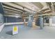 Unfinished basement featuring painted cinder block walls and exposed ceiling at 3624 Wallace Ave, Indianapolis, IN 46218