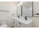 Beautiful bathroom featuring double sinks, modern fixtures, and stylish mirrors at 3624 Wallace Ave, Indianapolis, IN 46218