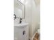 Elegant half bath with a modern vanity, black hardware, and a sleek faucet at 3624 Wallace Ave, Indianapolis, IN 46218