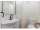 Elegant half bath with a modern vanity, black hardware, and a sleek faucet at 3624 Wallace Ave, Indianapolis, IN 46218