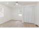 Bright bedroom with neutral carpet, a ceiling fan, two windows, and a closet with folding doors at 3624 Wallace Ave, Indianapolis, IN 46218