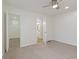 Bright bedroom with a ceiling fan, neutral carpet, an ensuite bathroom, and a spacious walk-in closet at 3624 Wallace Ave, Indianapolis, IN 46218