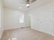 Well-lit bedroom with a ceiling fan, plush neutral carpet, and a closet with doors at 3624 Wallace Ave, Indianapolis, IN 46218