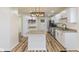 Modern kitchen featuring white cabinets, granite countertops and an island with stainless steel appliances at 3624 Wallace Ave, Indianapolis, IN 46218