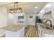 Well-lit kitchen featuring white cabinets, stainless steel appliances, and a granite countertop island at 3624 Wallace Ave, Indianapolis, IN 46218