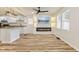 Open-concept living room featuring a fireplace and updated kitchen at 3624 Wallace Ave, Indianapolis, IN 46218