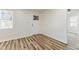 Bright room with wood floors, white walls, and a view to the adjacent rooms at 3624 Wallace Ave, Indianapolis, IN 46218