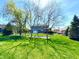Expansive backyard featuring a well-manicured lawn and mature trees, creating a private and peaceful outdoor space at 4414 Hickory Grove Blvd, Greenwood, IN 46143
