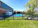 Large backyard with a beautiful pool, fence, and ample green space at 4414 Hickory Grove Blvd, Greenwood, IN 46143