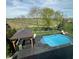Aerial view of beautiful backyard featuring in ground pool, covered patio, and golf course views at 4414 Hickory Grove Blvd, Greenwood, IN 46143