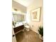 Modern half bath with a floating vanity, a lighted mirror, and stylish tile flooring for a clean and elegant design at 4414 Hickory Grove Blvd, Greenwood, IN 46143