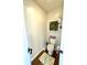 Cozy half bathroom with a decorative succulent wall display and hardwood floors at 4414 Hickory Grove Blvd, Greenwood, IN 46143