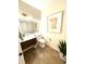 Modern half bath with a floating vanity, a lighted mirror, and stylish tile flooring for a clean and elegant design at 4414 Hickory Grove Blvd, Greenwood, IN 46143