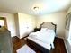 Bedroom with hardwood floors, a bed with an upholstered headboard, and a storage bench at 4414 Hickory Grove Blvd, Greenwood, IN 46143