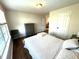 Cozy bedroom with hardwood floors, a large window, and neutral-toned decor at 4414 Hickory Grove Blvd, Greenwood, IN 46143