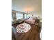 A spacious bedroom with a floral rug, large window, chandelier, and stylish decor at 4414 Hickory Grove Blvd, Greenwood, IN 46143