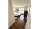 Bright bedroom featuring hardwood floors, a window, and a gray upholstered bed at 4414 Hickory Grove Blvd, Greenwood, IN 46143
