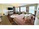 A large bedroom with a floral rug, dresser, and large windows for plenty of light at 4414 Hickory Grove Blvd, Greenwood, IN 46143