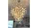 Close up of a stylish chandelier hanging in a home with hardwood floors at 4414 Hickory Grove Blvd, Greenwood, IN 46143