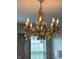 Elegant gold chandelier with leaf accents and crystal pendants illuminates the home at 4414 Hickory Grove Blvd, Greenwood, IN 46143