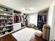 Spacious walk-in closet boasts custom storage, including shelving, cabinets, hanging rods, and an ottoman at 4414 Hickory Grove Blvd, Greenwood, IN 46143