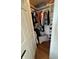 Organized walk-in closet features ample storage with hanging rods and shelving with hardwood floor at 4414 Hickory Grove Blvd, Greenwood, IN 46143