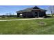 Exterior of the community clubhouse surrounded by lush greenery and a paved walkway at 4414 Hickory Grove Blvd, Greenwood, IN 46143