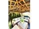 Large sectional couch with decorative pillows under the covered patio featuring a ceiling fan and lighting at 4414 Hickory Grove Blvd, Greenwood, IN 46143