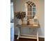 Inviting entryway features a wooden accent table decorated with a vase, lantern, and mosaic lamp at 4414 Hickory Grove Blvd, Greenwood, IN 46143