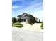Beautiful two-story home featuring a well-manicured lawn and concrete driveway on a bright day at 4414 Hickory Grove Blvd, Greenwood, IN 46143