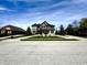 Beautiful two-story house with an expansive driveway and lush greenery in a suburban setting at 4414 Hickory Grove Blvd, Greenwood, IN 46143