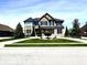 Charming two-story home with a well-manicured lawn, lush landscaping, and a welcoming curb appeal at 4414 Hickory Grove Blvd, Greenwood, IN 46143