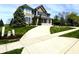 Beautiful two-story house with an expansive driveway and lush greenery in a suburban setting at 4414 Hickory Grove Blvd, Greenwood, IN 46143