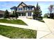 Charming two-story home with a landscaped front yard and a spacious driveway on a sunny day at 4414 Hickory Grove Blvd, Greenwood, IN 46143