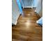 Hallway features hardwood floors and white trim, leading to the entryway with a decorative accent table at 4414 Hickory Grove Blvd, Greenwood, IN 46143