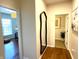 Hallway featuring hard wood floors with view into multiple rooms at 4414 Hickory Grove Blvd, Greenwood, IN 46143
