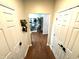 View down hardwood hallway between two closed doors into the living area at 4414 Hickory Grove Blvd, Greenwood, IN 46143