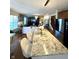 Open concept kitchen offers granite countertops and island seating, flowing into the living area at 4414 Hickory Grove Blvd, Greenwood, IN 46143