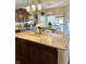 A kitchen island with granite countertops overlooks a dining area with natural light at 4414 Hickory Grove Blvd, Greenwood, IN 46143