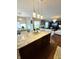 Granite kitchen island overlooks a dining area and living room with bright lighting at 4414 Hickory Grove Blvd, Greenwood, IN 46143